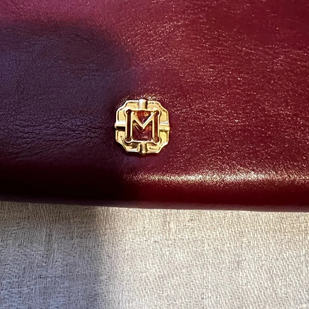 Vintage Monet zip around wallet with tassel on zipper. Maroon in color.